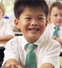 young boy in classroom smiling
