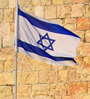 Israeli flag against an ancient wall
