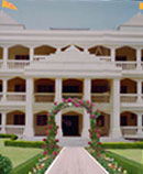 three story white building in a classical style